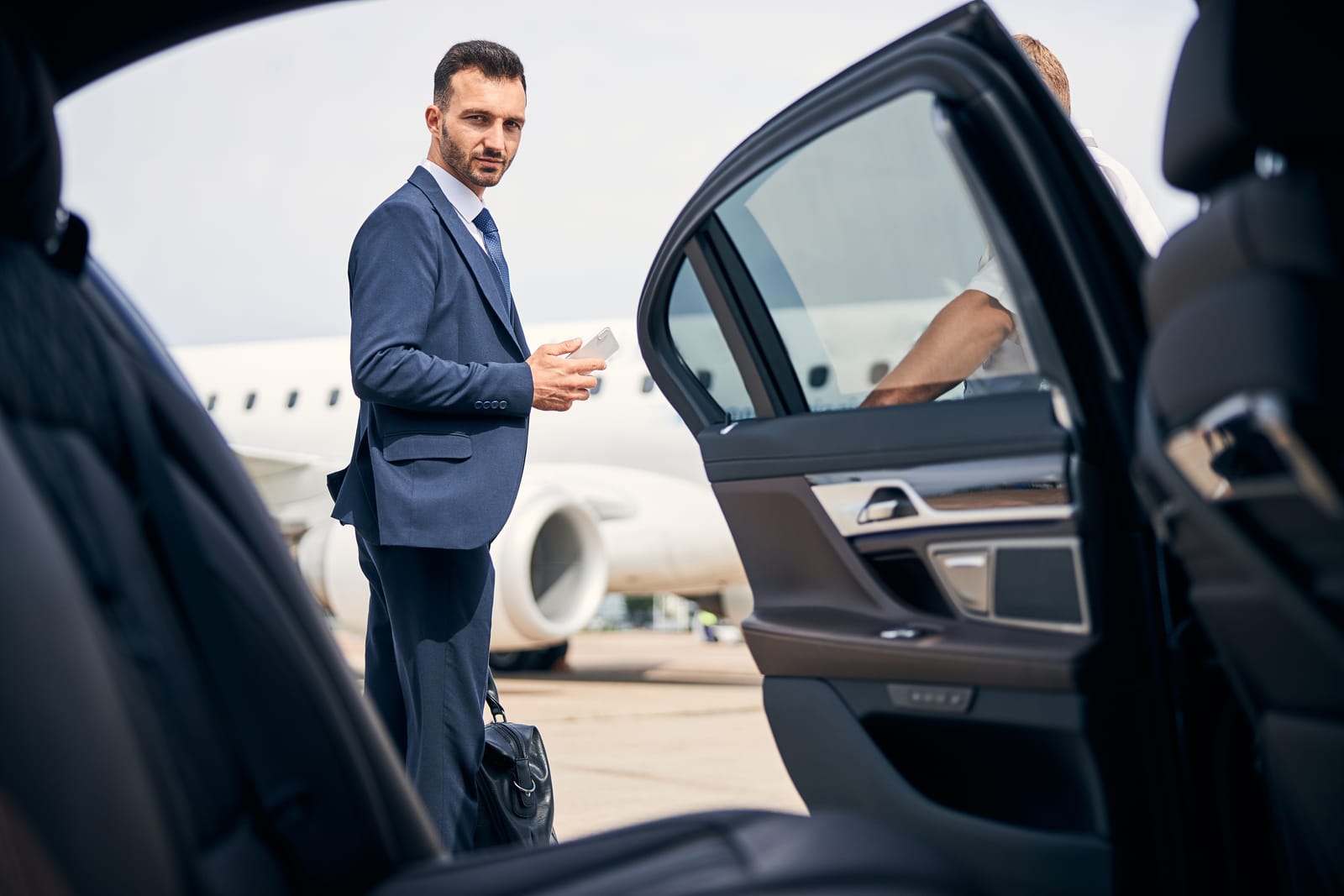 A well-dressed traveller met at the aircraft by a private car