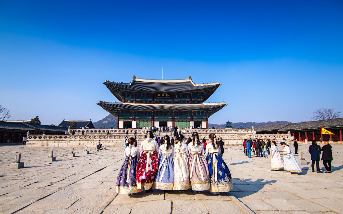 Visitors in hanbok before the main hall of Gyeongbokgung Palace, Seoul