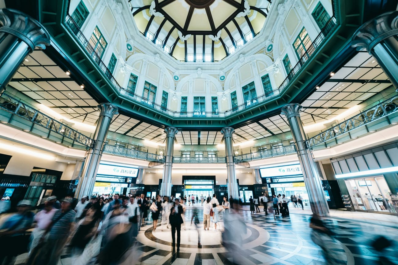 Rush-hour crowds blurred in motion inside Tokyo Station